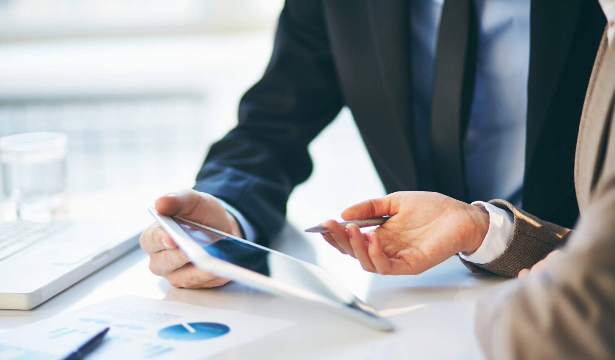 Female hand during explanation of report in touchpad